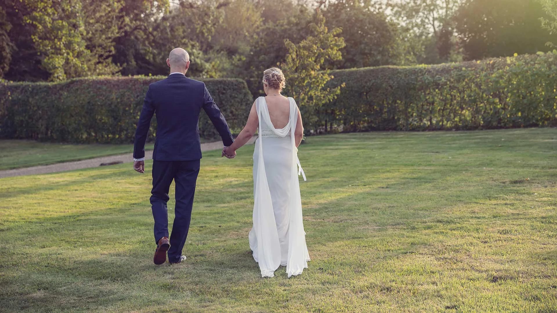 A couple walking hand in hand — still from Andy's wedding film